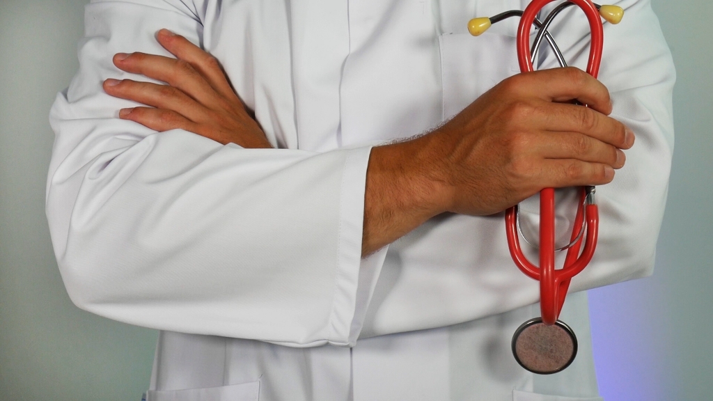 close up of doctor crossing arms