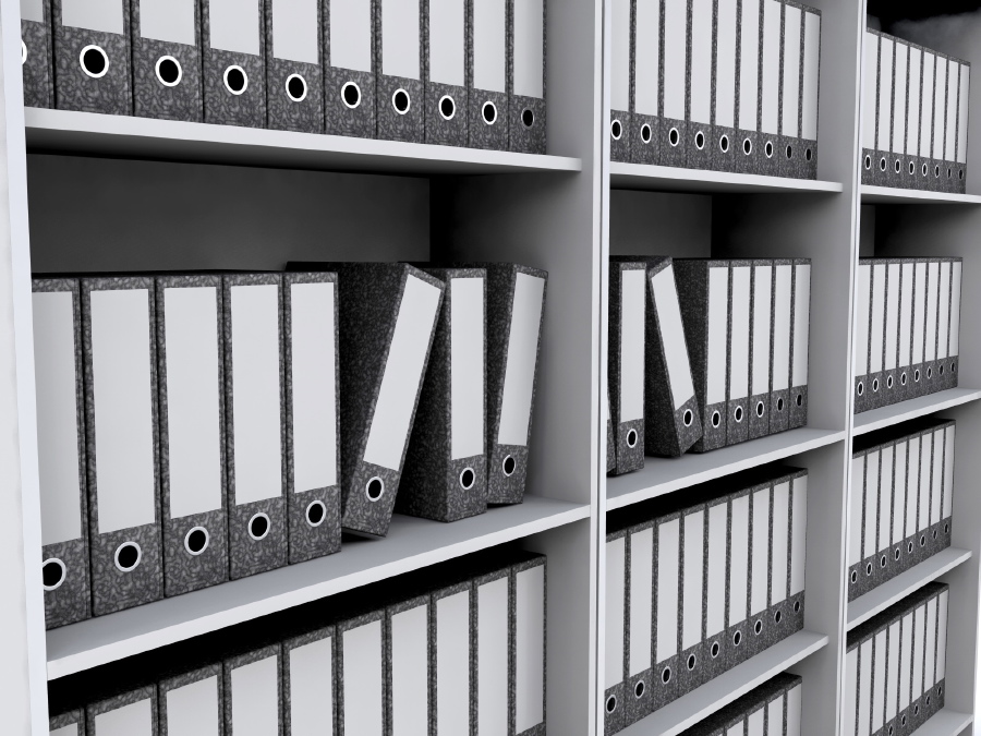 stack of binders on a shelf